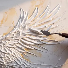 Close-up of a palette knife sculpting raised white feathers